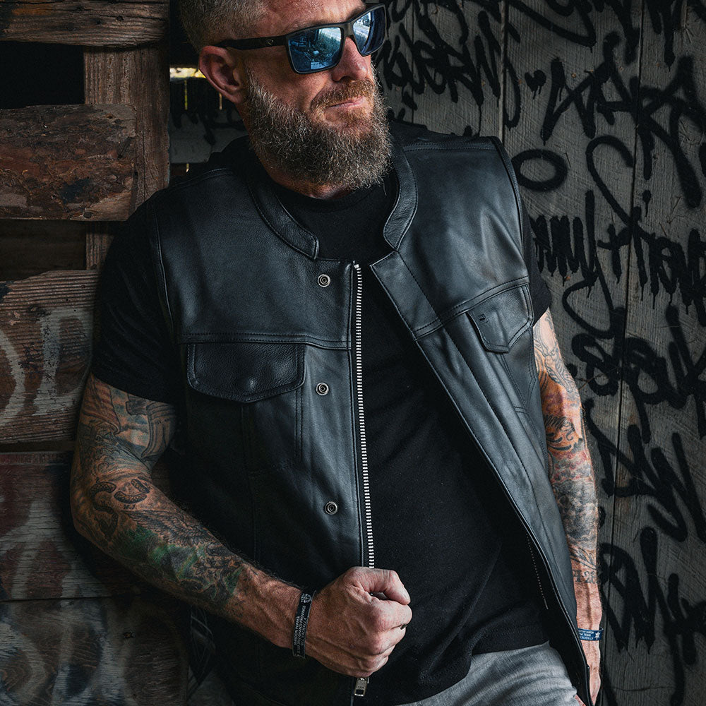The Men's Ultra SOA Style Club Vest by Unik Ultra blends iconic design with practical features. Made from cowhide leather, it includes four exterior pockets, two inside concealed carry pockets, a zip snap main closure