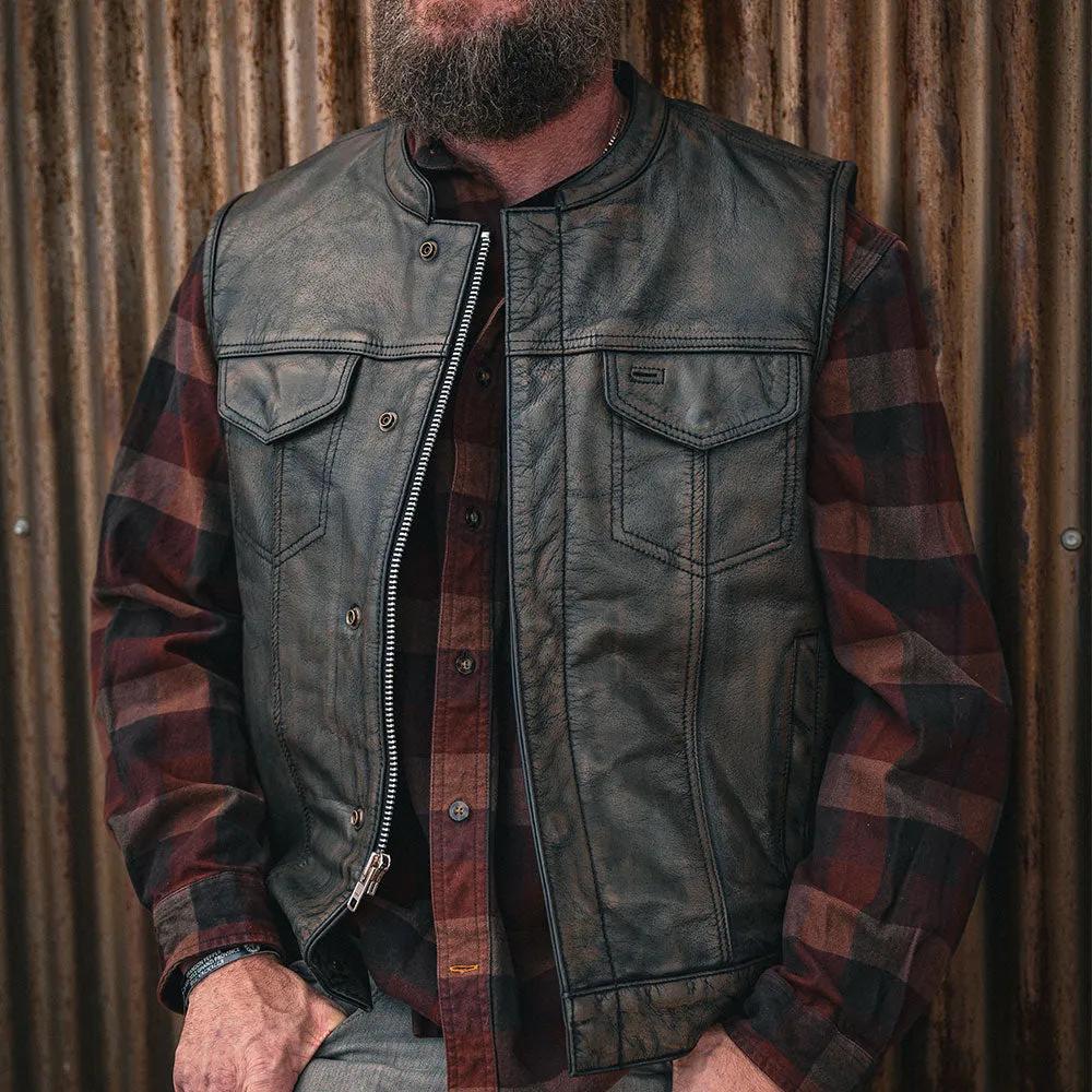 Crafted from buffalo leather, it features two outside chest pockets, two outside hand warmer pockets, two inside concealed carry pockets, antique brass hardware, a quick access gun pocket