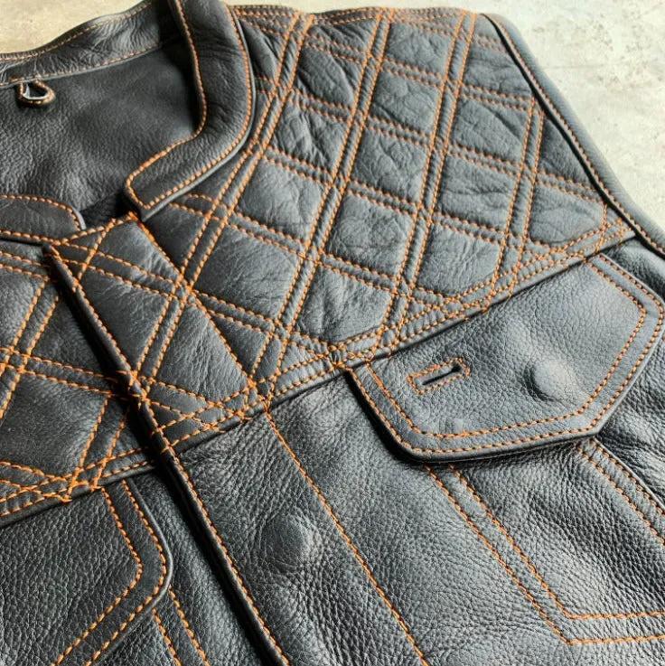 Made from cowhide leather with a diamond stitch pattern, it includes four exterior pockets, two inside concealed carry pockets.