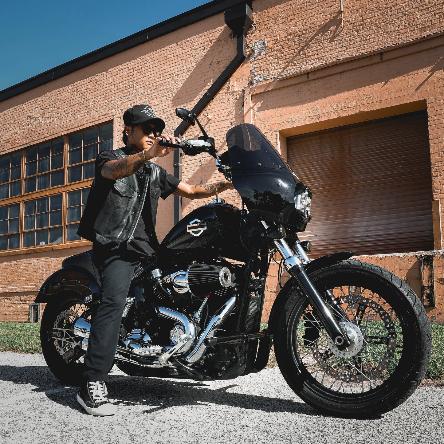 Made from cowhide leather, it includes four exterior pockets, two inside concealed carry pockets, a zip snap main closure, antique brass hardware, and a one-panel back, offering both style and functionality for various settings.
