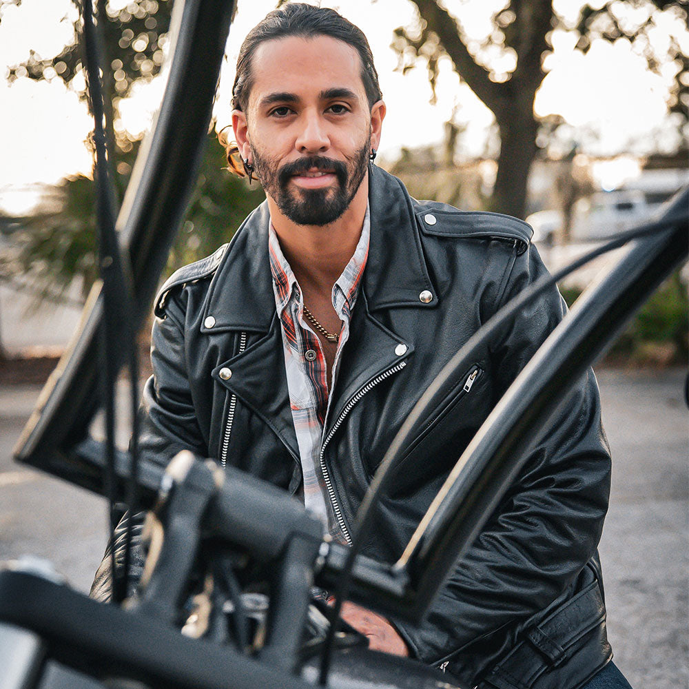 It features practical elements such as a full removable belt, multiple pockets including two inside concealed carry pockets, and zippered cuffs.