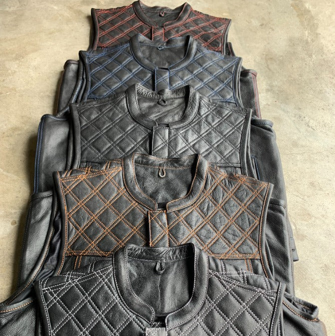Made from cowhide leather with a diamond stitch pattern, it includes four exterior pockets, two inside concealed carry pockets.