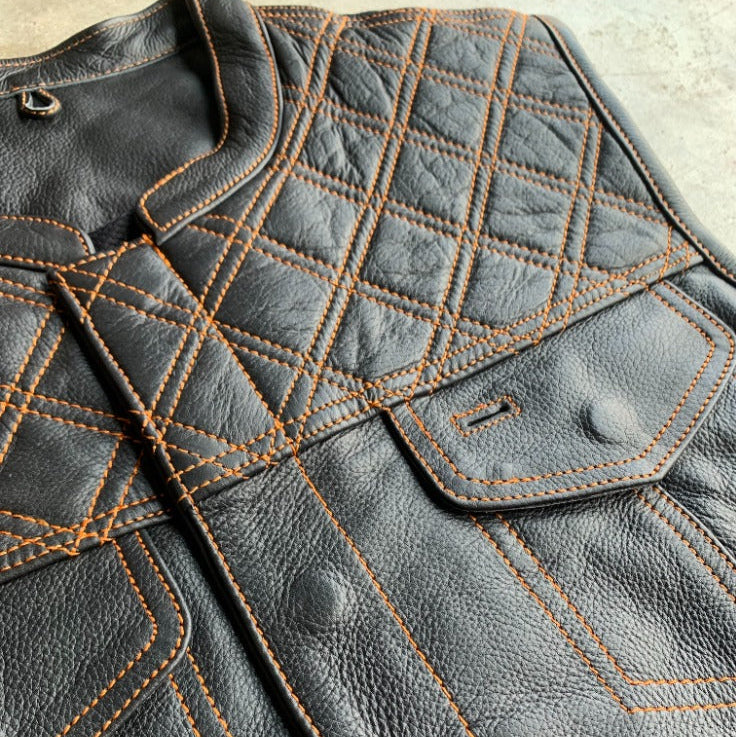 Made from cowhide leather with a diamond stitch pattern, it includes four exterior pockets, two inside concealed carry pockets.
