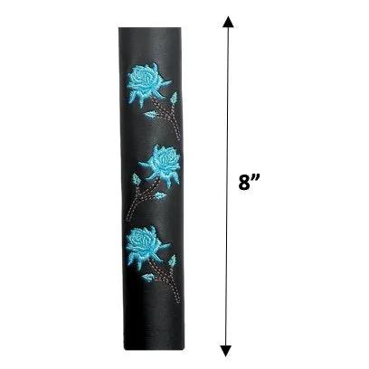 leather cylindrical object with blue floral designs and a measurement 