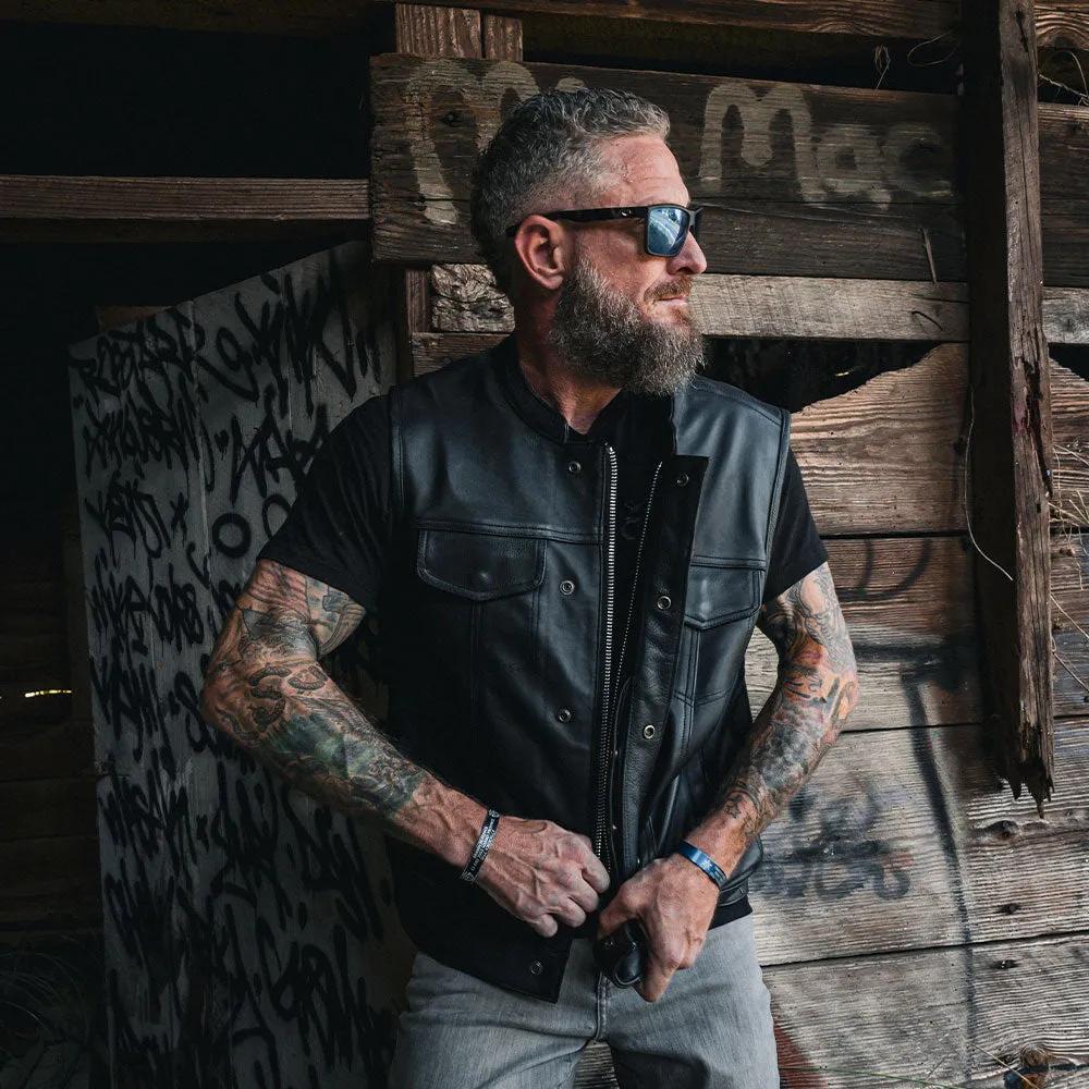 The Men's Ultra SOA Style Club Vest by Unik Ultra blends iconic design with practical features. Made from cowhide leather, it includes four exterior pockets, two inside concealed carry pockets, a zip snap main closure, antique brass hardware