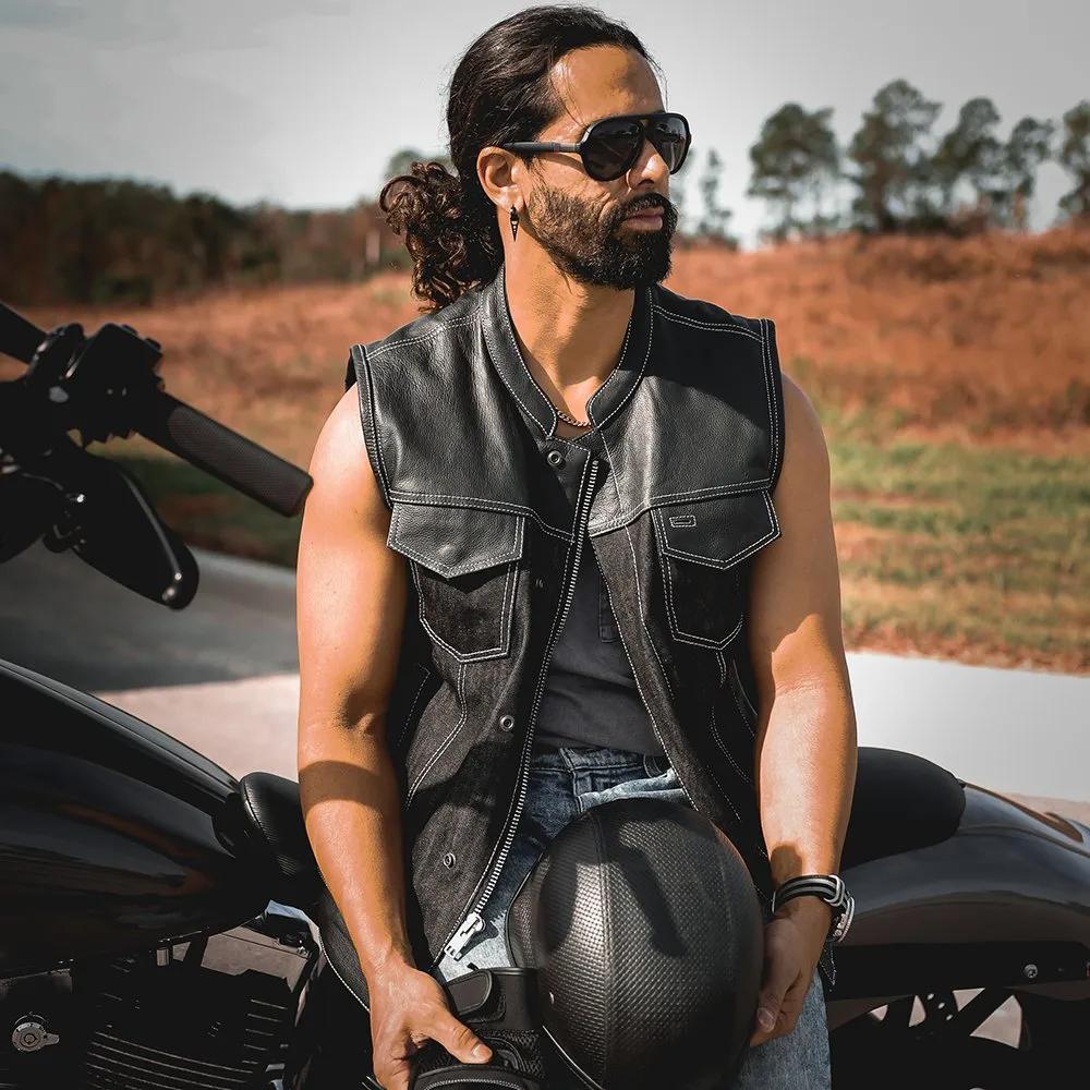 Man in a leather vest sitting on a motorcycle lifestyle image