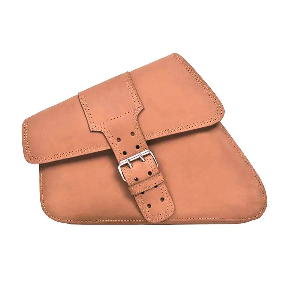 Tan leather satchel with a buckle starp