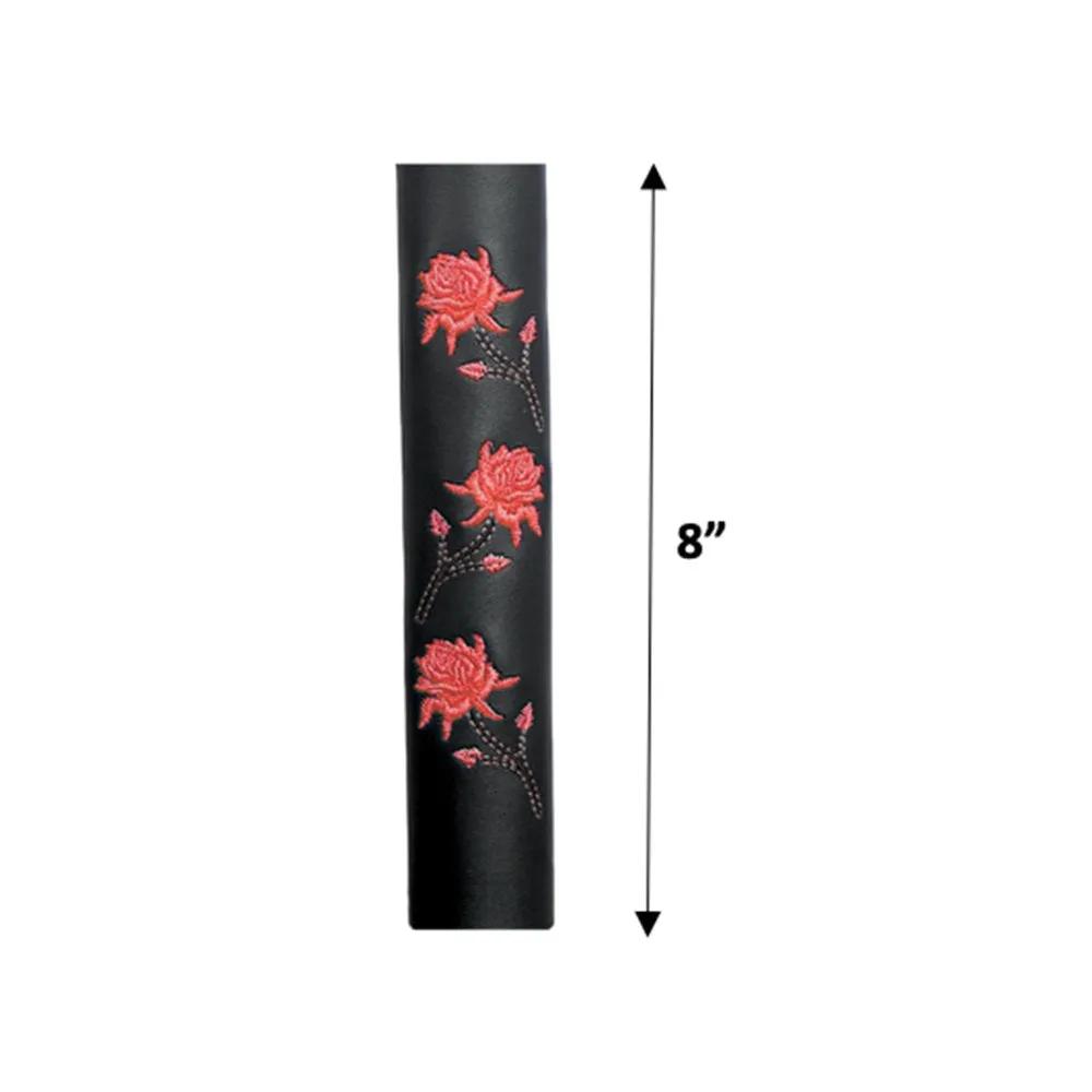 cylindrical object with red floral designs